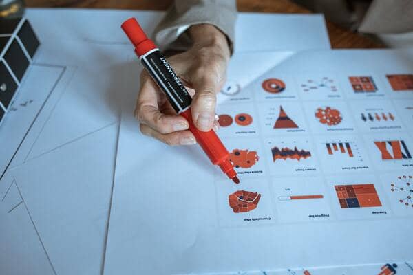 a person is analyzing data charts and graphs to optimize medical machine learning project